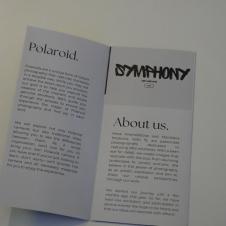 A brochure with two pages, the left page discussing Polaroid photography and the right page titled 'About us.' The left side explains the uniqueness of Polaroid photos, while the right side introduces two young photographers, Anna Krasnolobova and Stanislava Moskvina, who are passionate about photography. At the top, the word 'Symphony' is stylized in bold lettering.